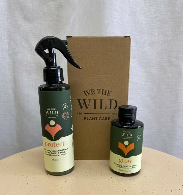 Two bottles of plant care product and a cardboard box